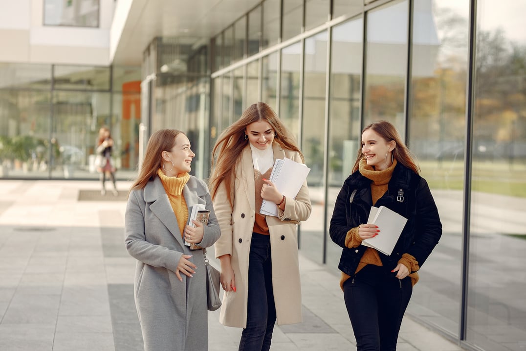 Smiling students discussing day in college